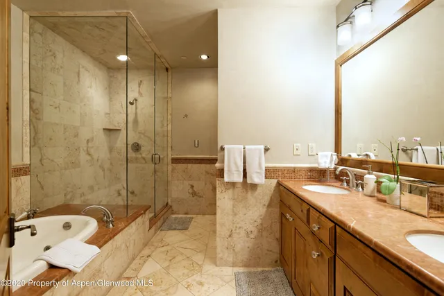 a bathroom with a tub sink and mirror