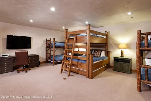 a bedroom with furniture and a flat screen tv