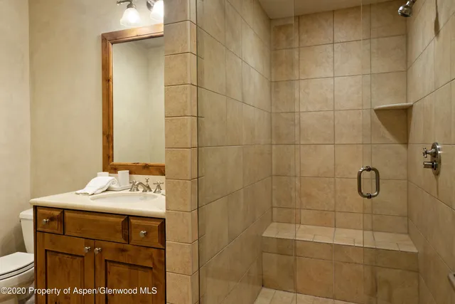 a bathroom with a sink toilet and shower