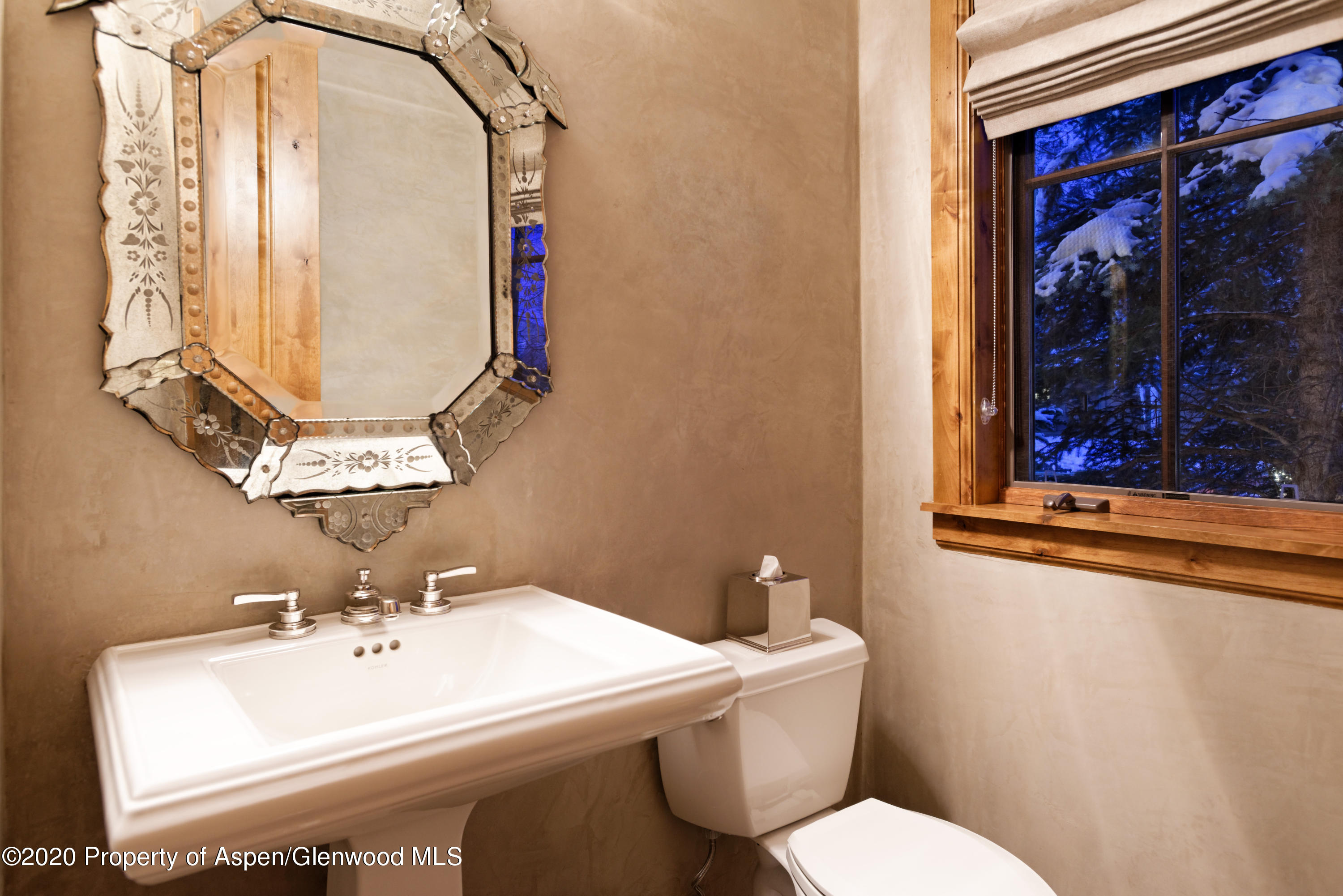 32 Prospector Road Aspen, CO 81611 - Photo 32 of 37 a bathroom with a toilet sink and mirror