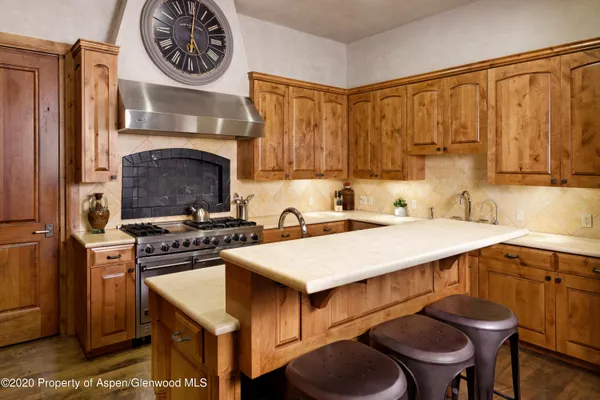 a kitchen with a stove and a refrigerator