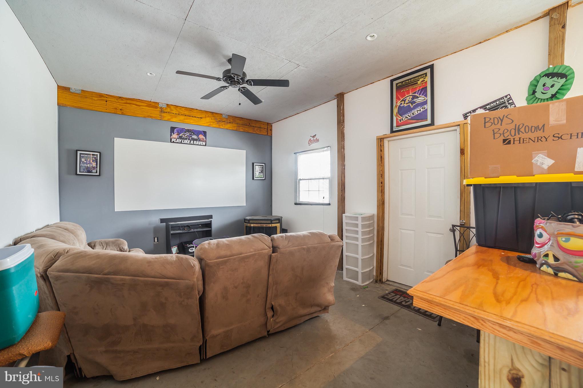 7859 Kentley Road Baltimore, MD 21222 - Photo 35 of 36 Game Room with Bar, Fridge and Sectional Couch.