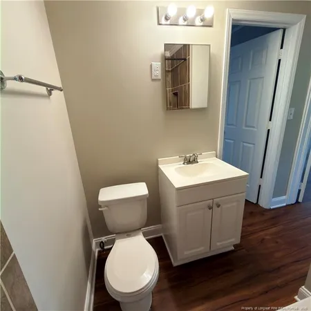a white toilet sitting next to a bathroom sink