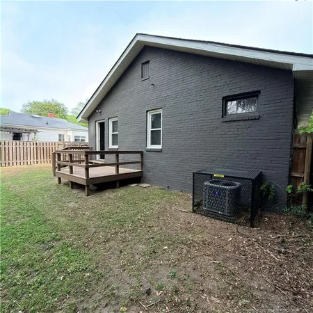 a backyard of a house with barbeque oven