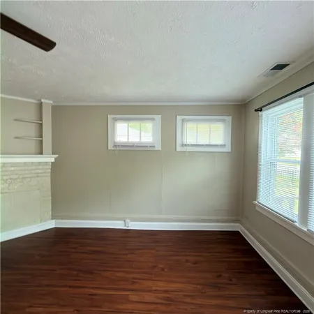 a view of a room with wooden floor and window