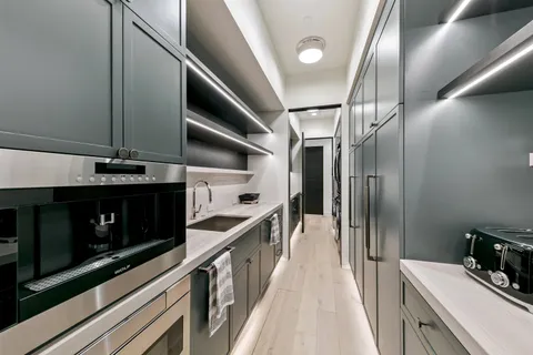 a kitchen with stainless steel appliances granite countertop a stove and a refrigerator