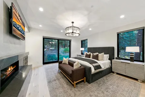 a spacious bedroom with a bed and a fireplace