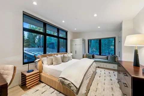 a bedroom with a large bed and a large window