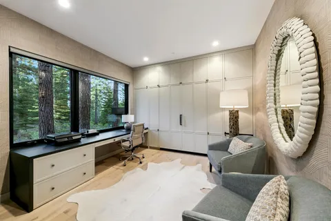 a spacious bathroom with a tub double vanity and a window