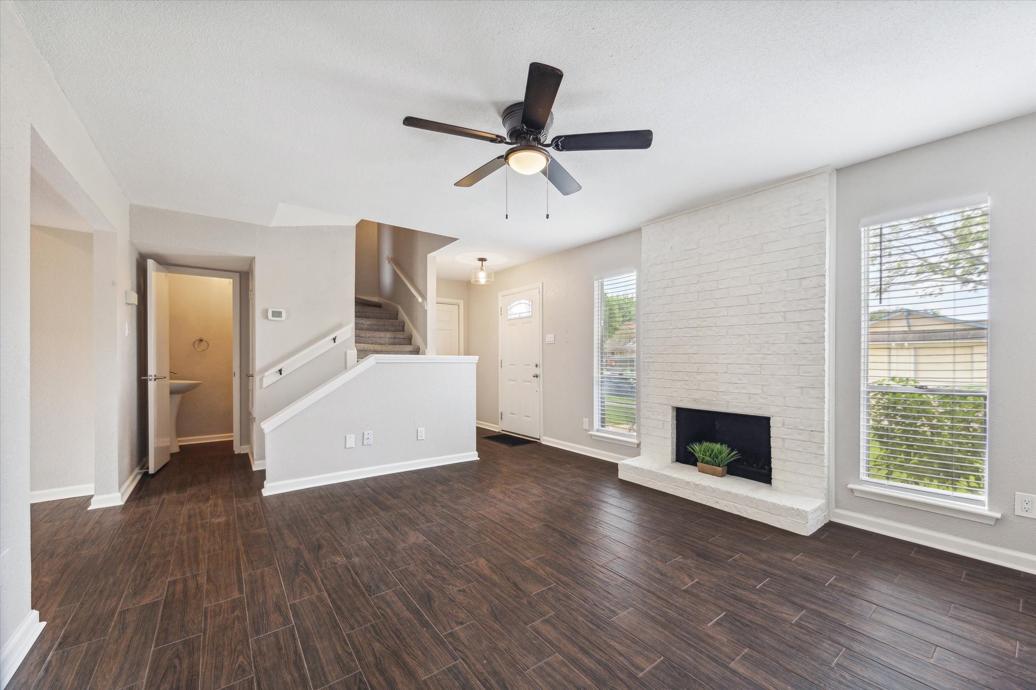 1428 Silverpines Road, Unit 428 Houston, TX 77062 - Photo 4 of 19 Generously sized living room features a wood-burning fireplace.