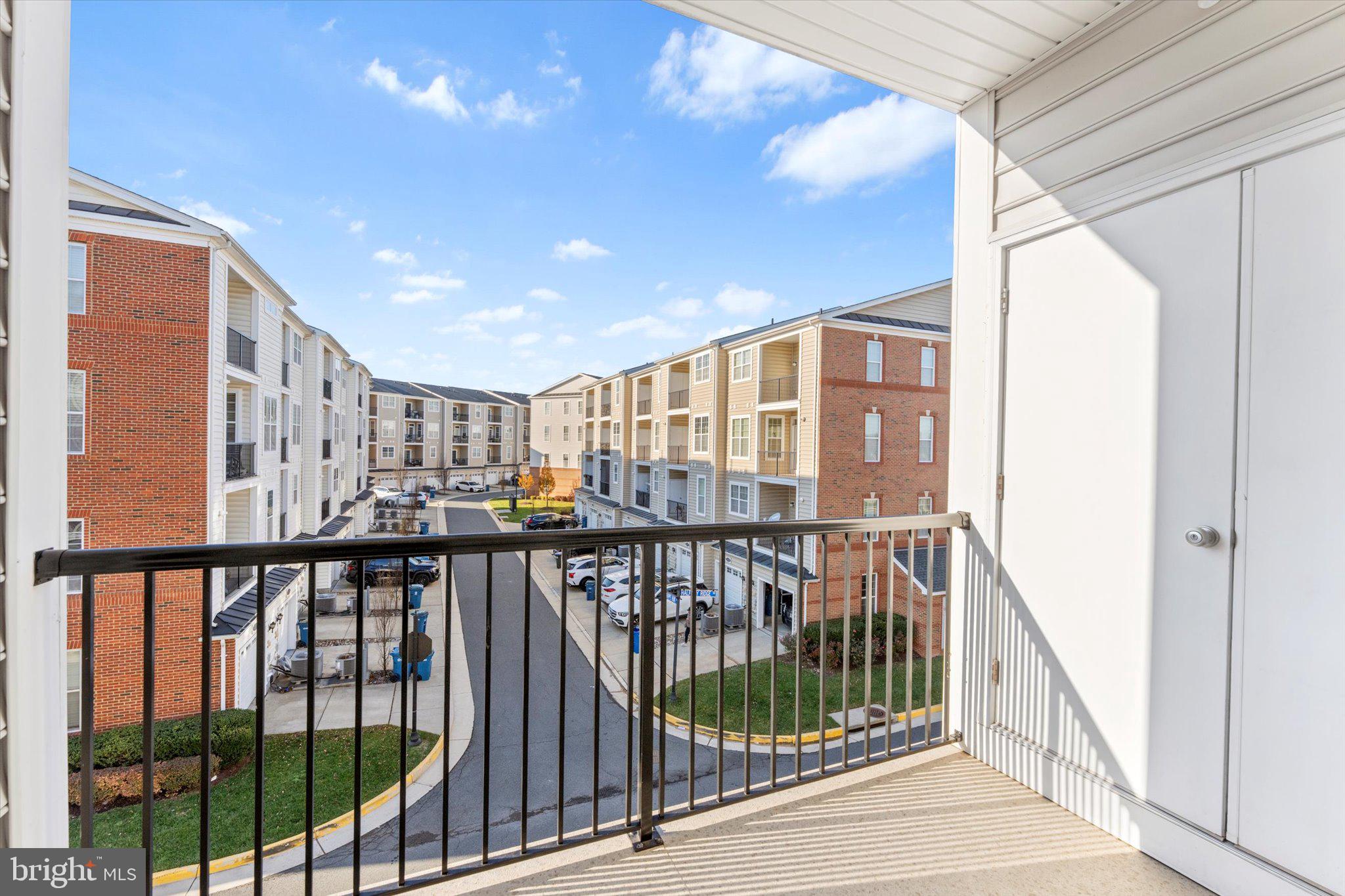 23483 Logans Ridge Terrace Ashburn, VA 20148 - Photo 12 of 35 a view of staircase with a large window and wooden floor