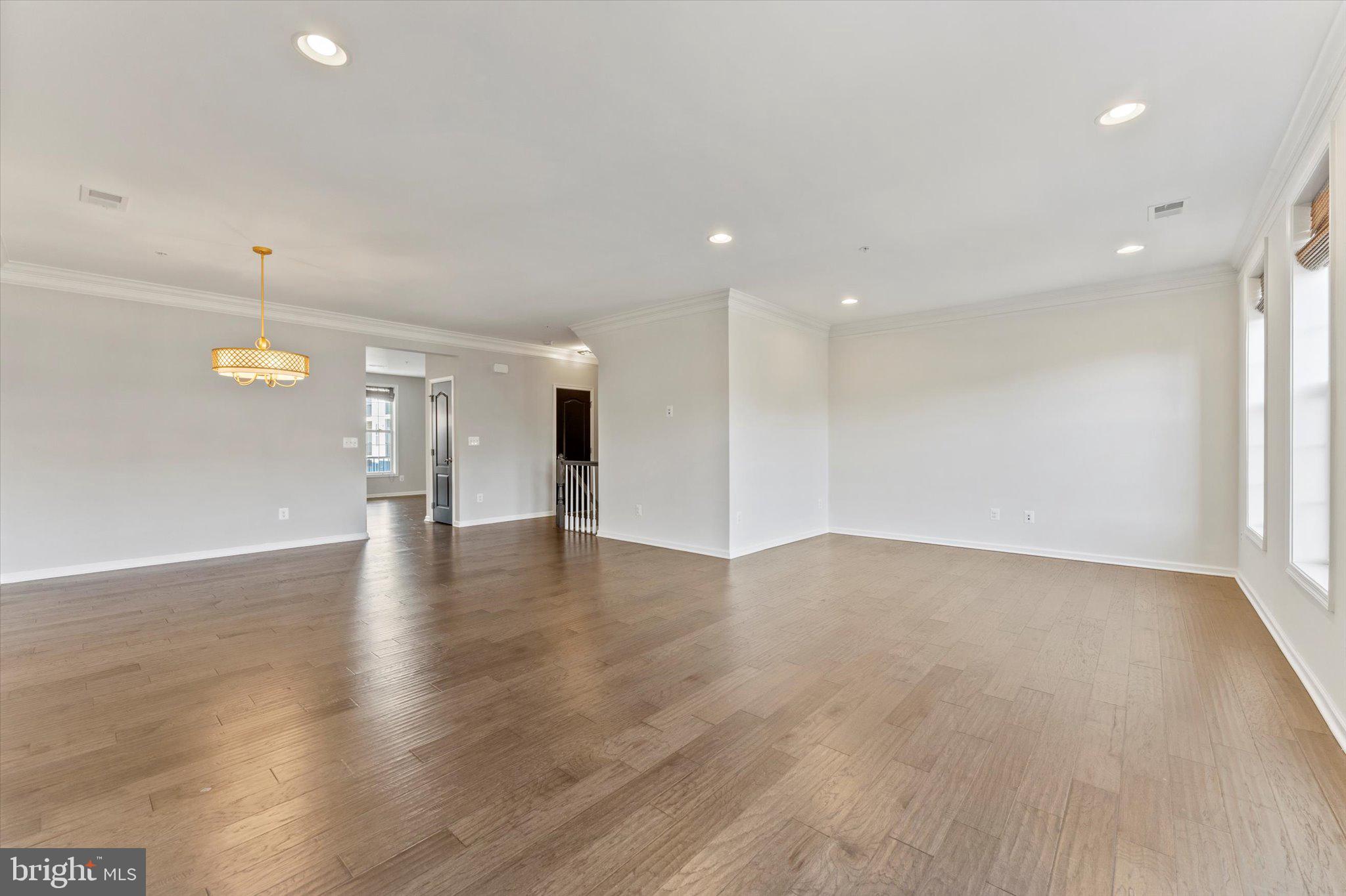 23483 Logans Ridge Terrace Ashburn, VA 20148 - Photo 15 of 35 a view of an empty room with wooden floor