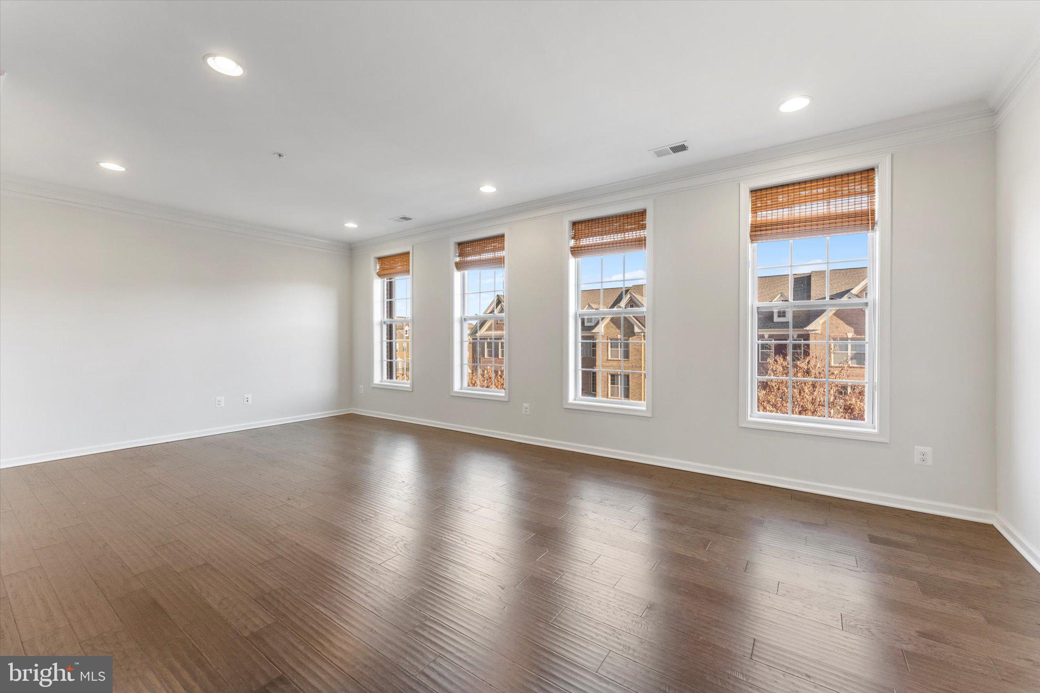 23483 Logans Ridge Terrace Ashburn, VA 20148 - Photo 16 of 35 a view of an empty room with wooden floor and window
