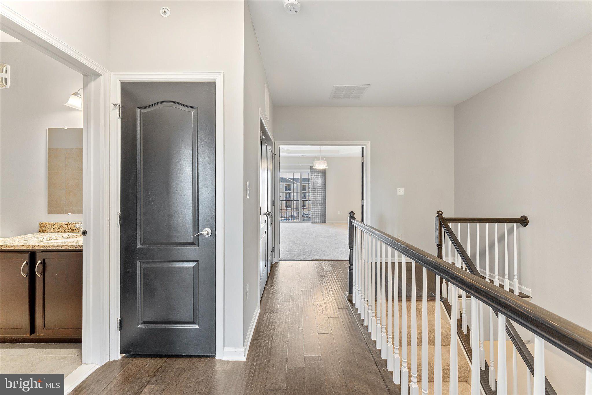 23483 Logans Ridge Terrace Ashburn, VA 20148 - Photo 20 of 35 a view of a hallway with wooden floor and staircase