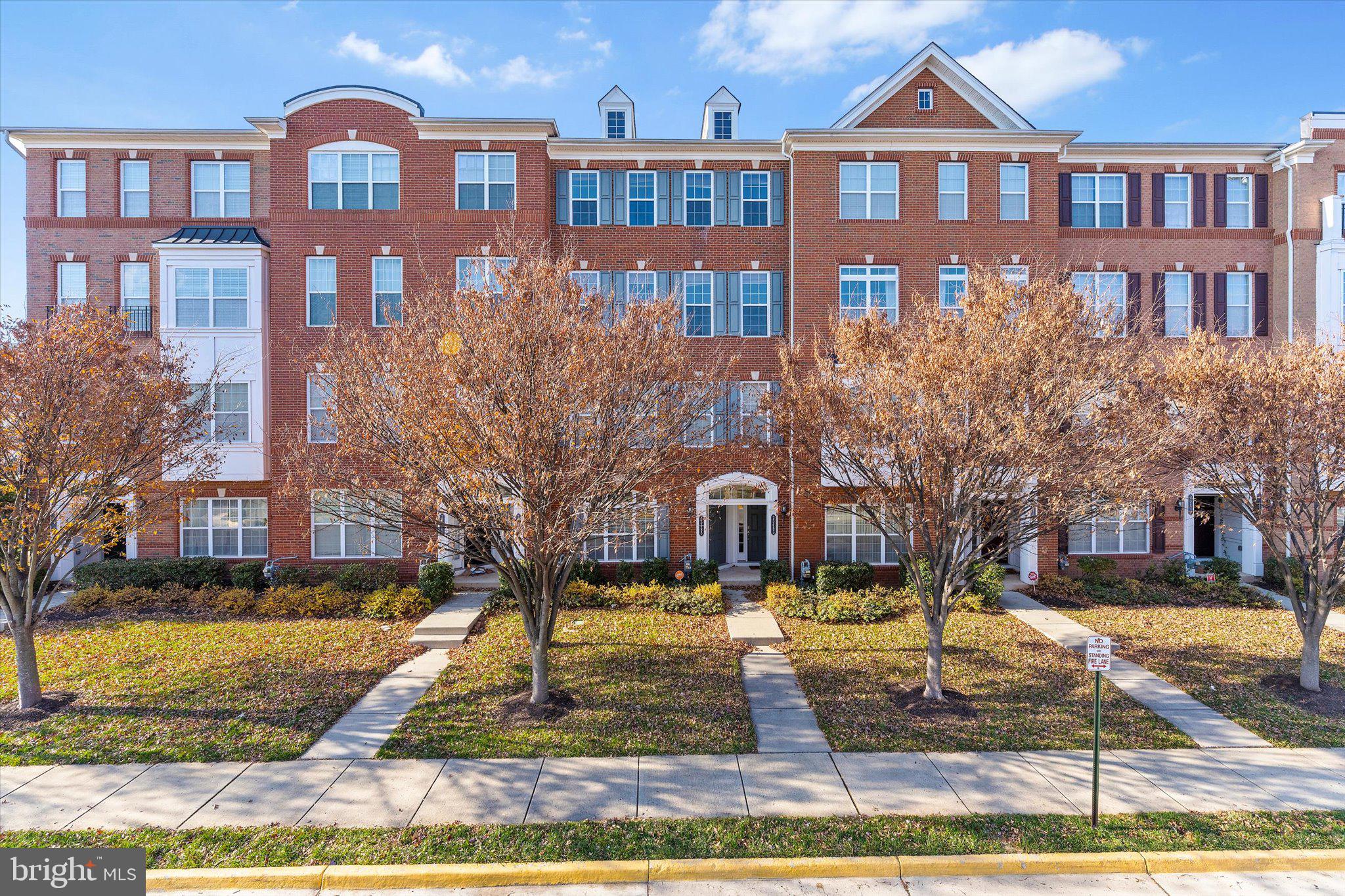 23483 Logans Ridge Terrace Ashburn, VA 20148 - Photo 2 of 35 a front view of a building with garden