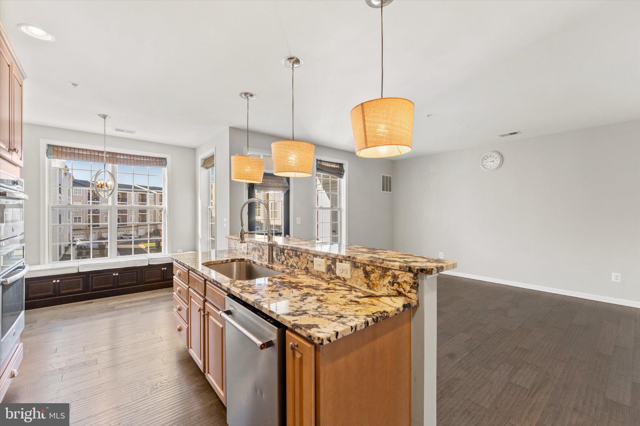 23483 Logans Ridge Terrace Ashburn, VA 20148 - Photo 9 of 35 a kitchen with a stove and a wooden floor