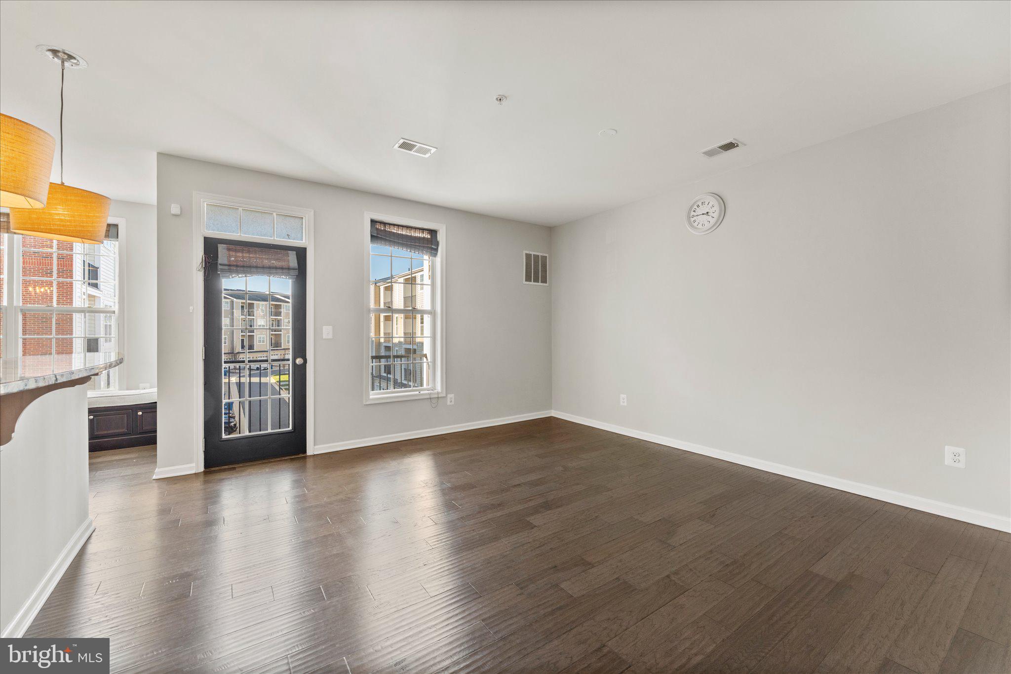 23483 Logans Ridge Terrace Ashburn, VA 20148 - Photo 10 of 35 a view of an empty room with wooden floor and a window
