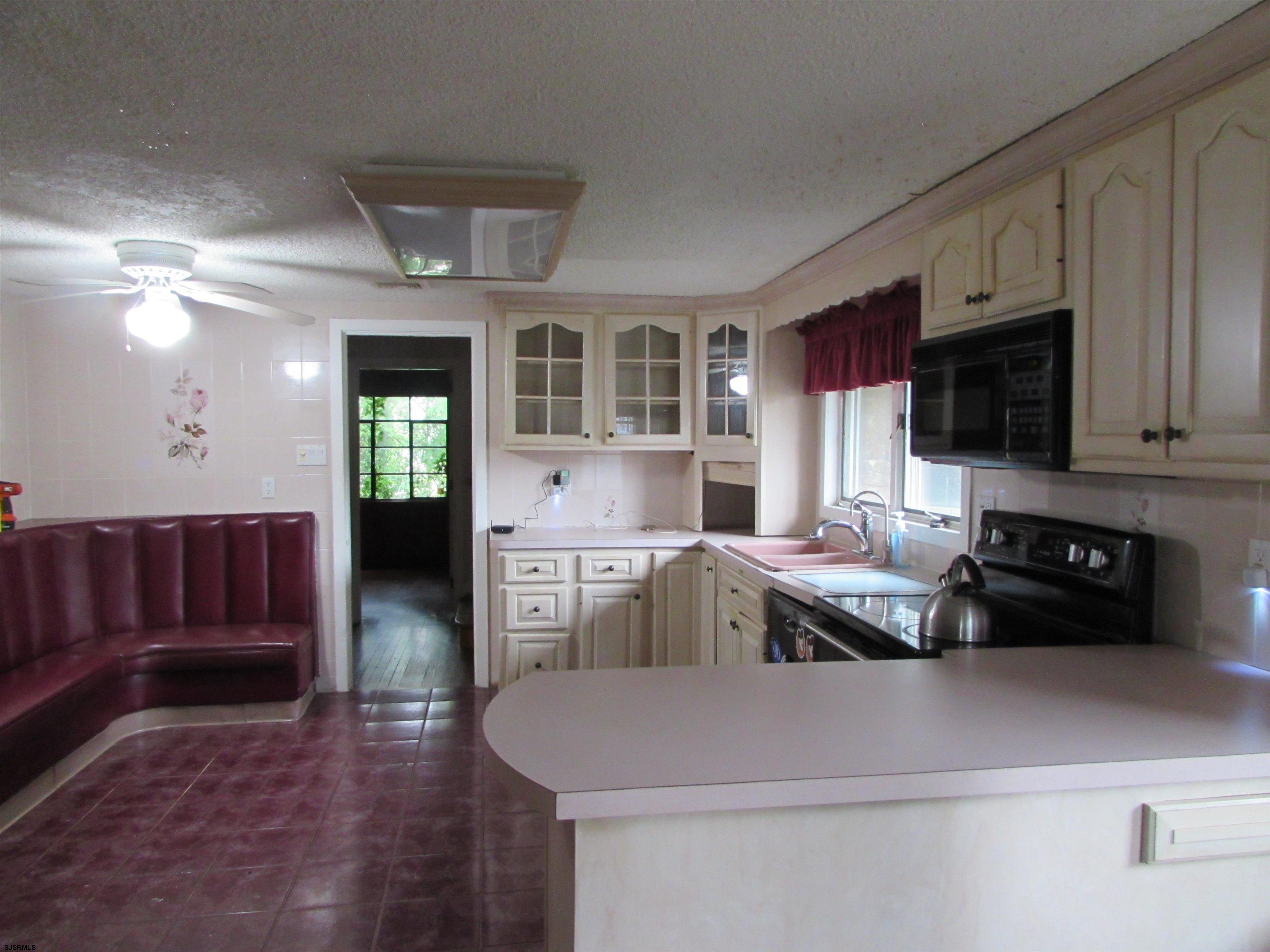 744 Shore Road Linwood, NJ 08221 - Photo 23 of 43 a kitchen with a refrigerator and a stove top oven