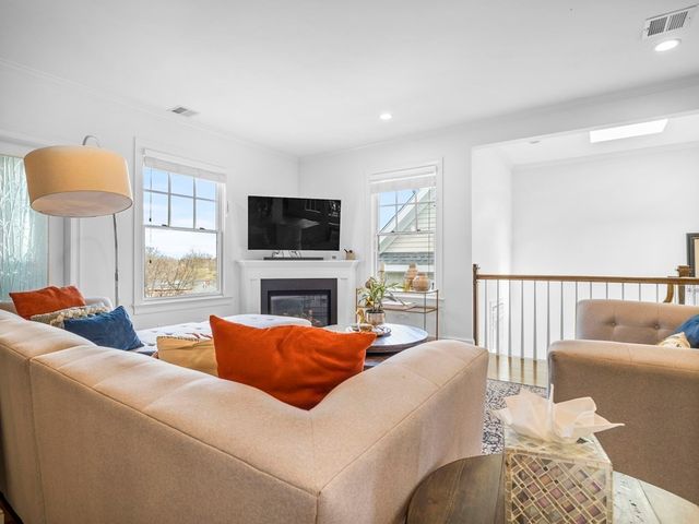 a living room with furniture a lamp and a flat screen tv