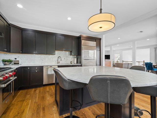 a kitchen with a table chairs sink and cabinets