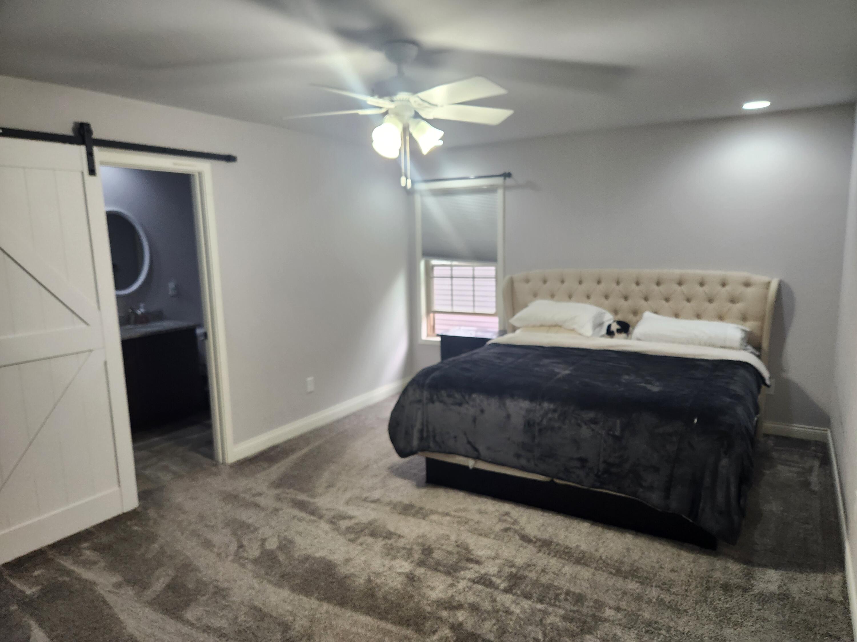 702 19th Street Southeast De Motte, IN 46310 - Photo 13 of 22 a bedroom with a bed and a chandelier