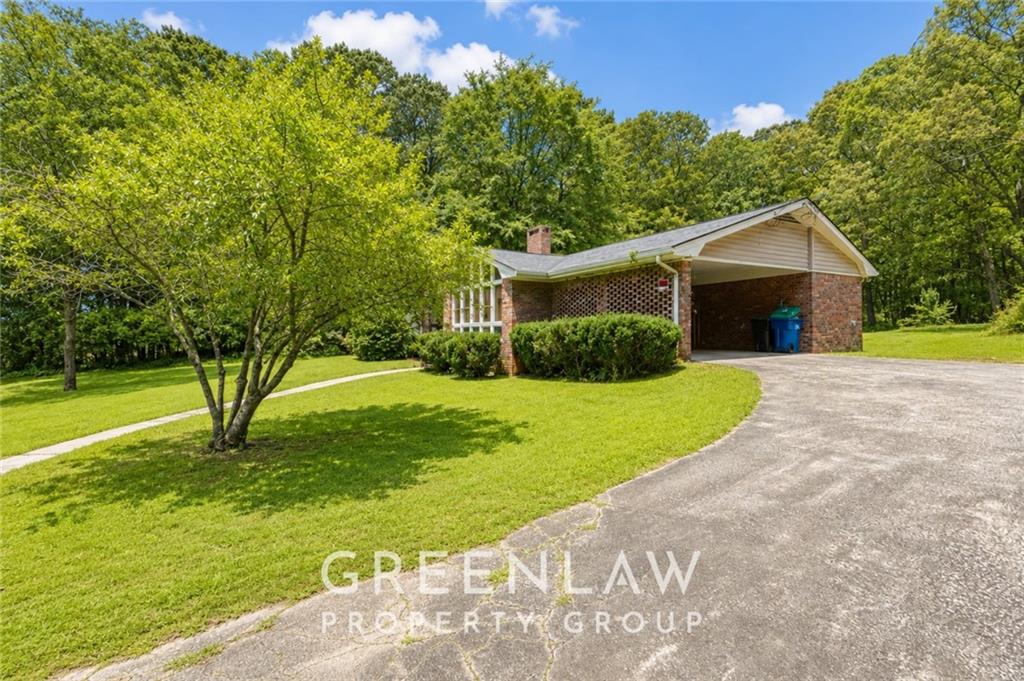 3605 Flat Shoals Road Atlanta, GA 30349 - Photo 3 of 35 a front view of a house with garden