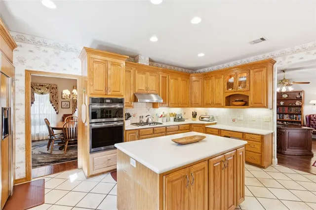 a kitchen with a stove a sink and a refrigerator