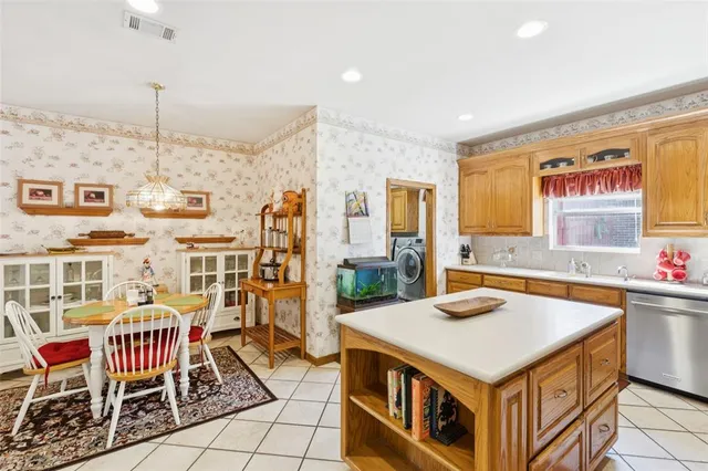 a kitchen that has a lot of cabinets in it and wooden floors
