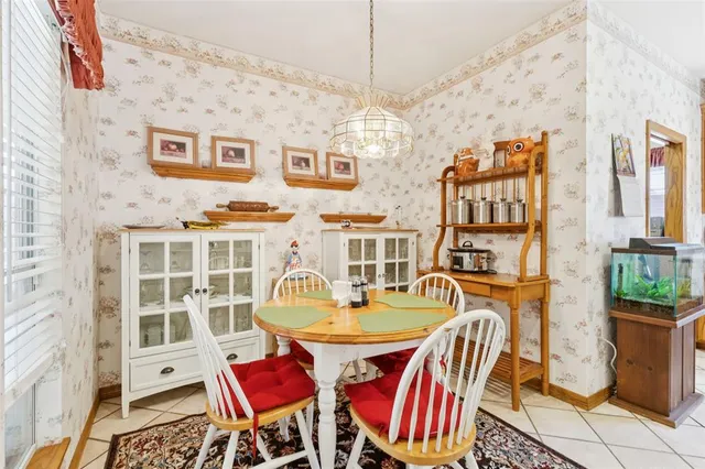 a dining room with furniture a rug and a chandelier