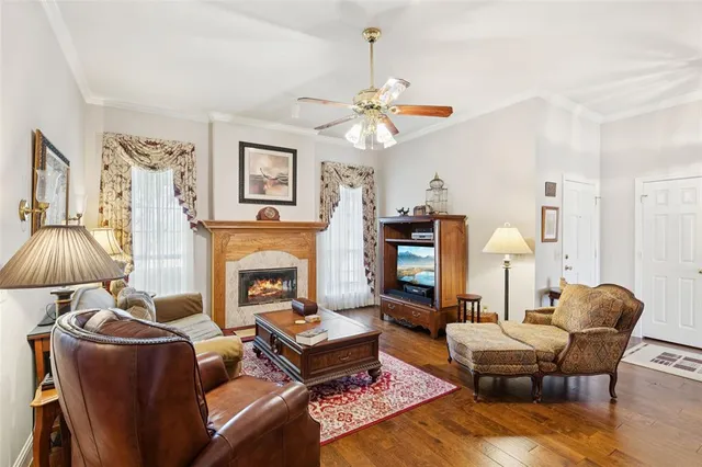 a living room with furniture a chandelier and a fireplace