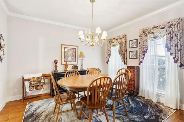 a view of a dining room with furniture and chandelier