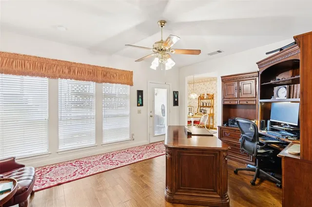a view of a workspace with furniture and a window