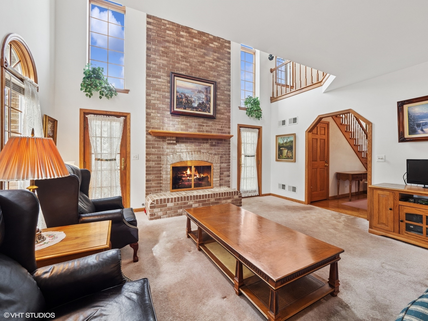 5580 Amanda Court Rolling Meadows, IL 60008 - Photo 2 of 18 a living room with furniture a flat screen tv and a fireplace