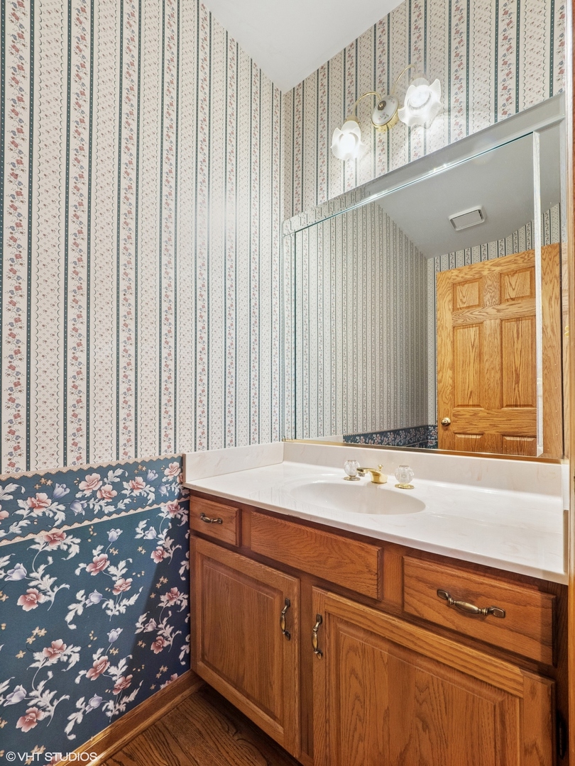 5580 Amanda Court Rolling Meadows, IL 60008 - Photo 8 of 18 a bathroom with a sink and a mirror