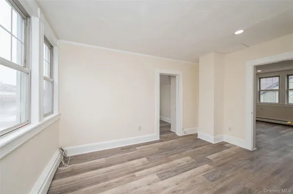 a view of room with window and hardwood floor