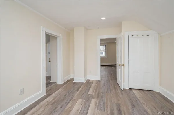 a view of a hallway with wooden floor