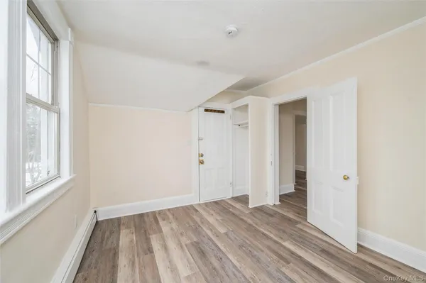 a view of a room with wooden floor and windows