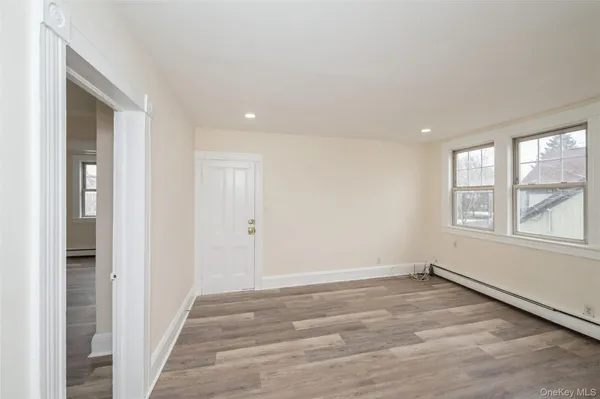 an empty room with windows and closet