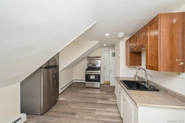a kitchen with granite countertop a sink and a stove top oven