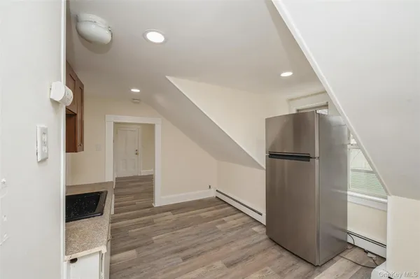 a view of kitchen with a refrigerator and microwave