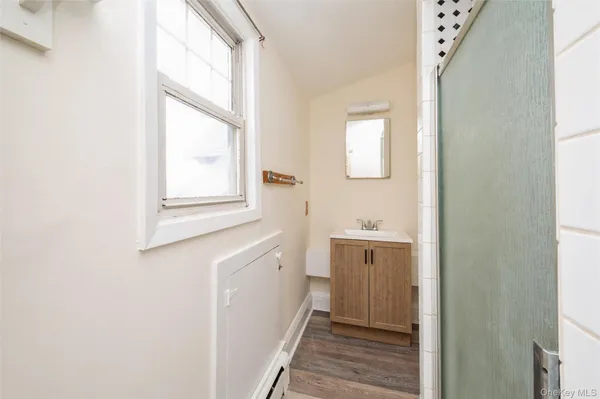 a bathroom with a sink a mirror and a window