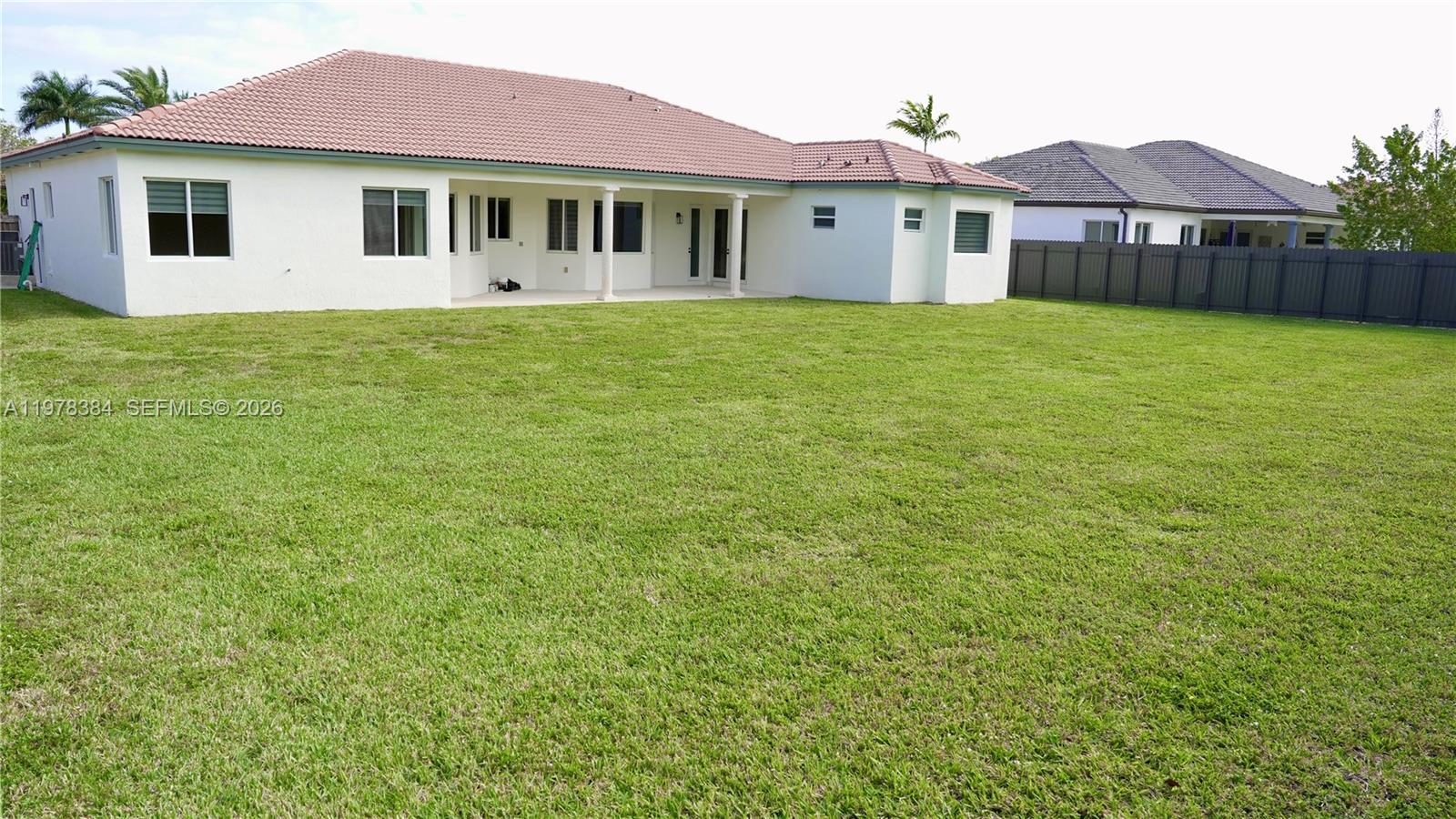 13162 Southwest 191st Terrace, Unit 1 Miami, FL 33177 - Photo 2 of 7 a view of a house with a yard