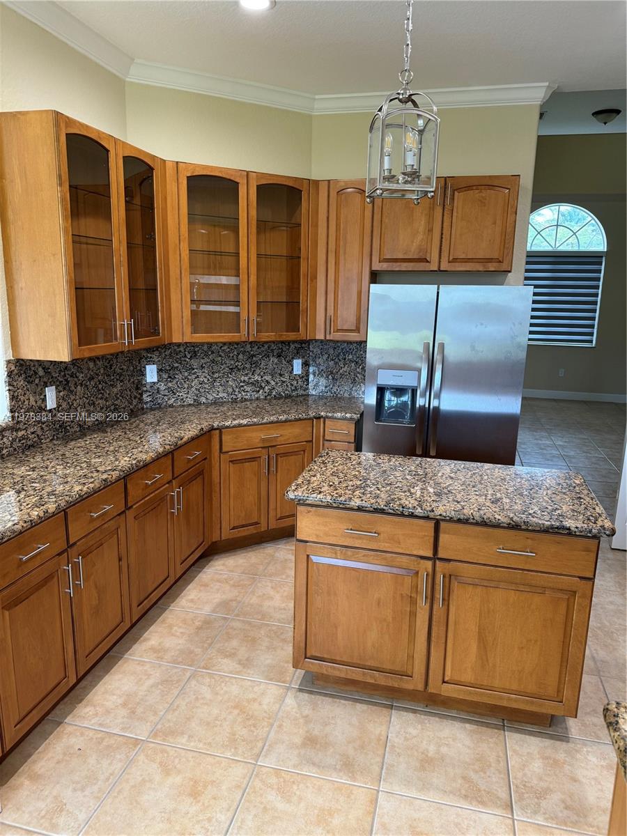 13162 Southwest 191st Terrace, Unit 1 Miami, FL 33177 - Photo 6 of 7 a kitchen with granite countertop a sink and cabinets