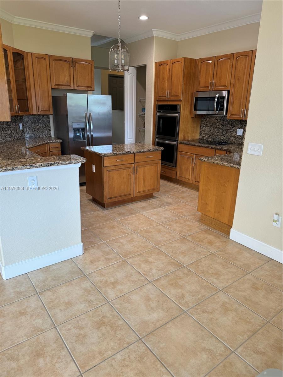 13162 Southwest 191st Terrace, Unit 1 Miami, FL 33177 - Photo 7 of 7 a kitchen with stainless steel appliances a refrigerator sink and microwave