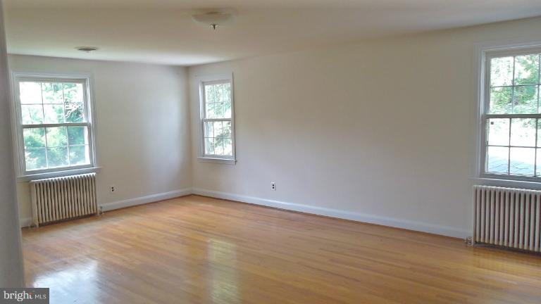 6301 Rt 32 Es Guilford Road Clarksville, MD 21029 - Photo 14 of 28 an empty room with wooden floor and windows