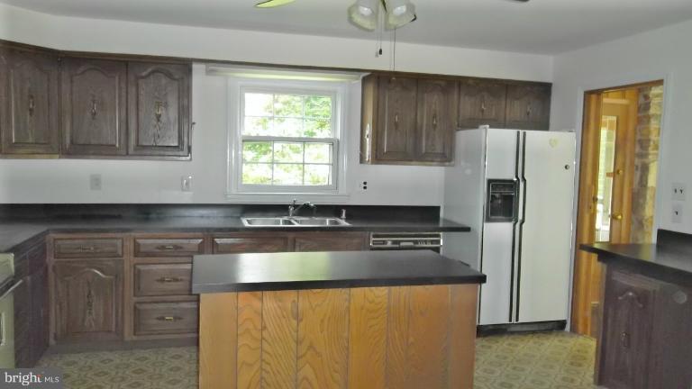 6301 Rt 32 Es Guilford Road Clarksville, MD 21029 - Photo 7 of 28 a kitchen with granite countertop a refrigerator stove and sink