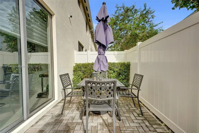a view of a chairs and table in the balcony