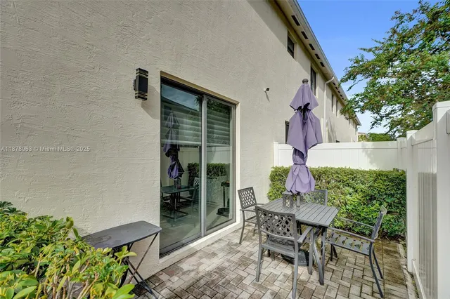 a view of backyard with outdoor seating and plants