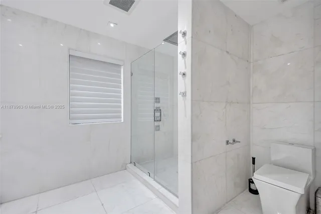 a bathroom with a shower and toilet