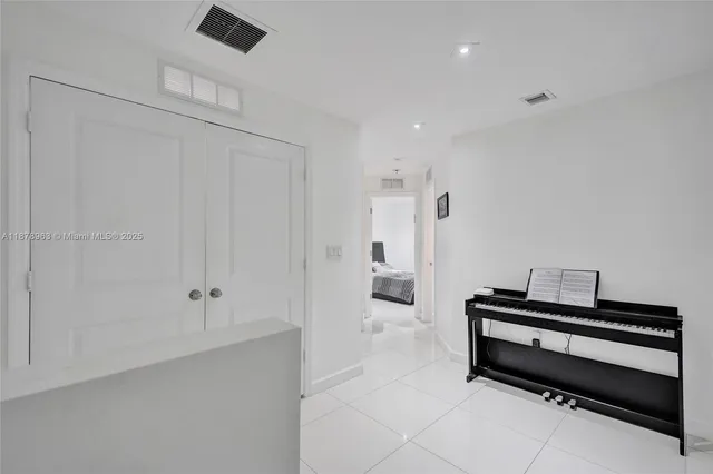 a spacious bedroom with a bed and a chandelier